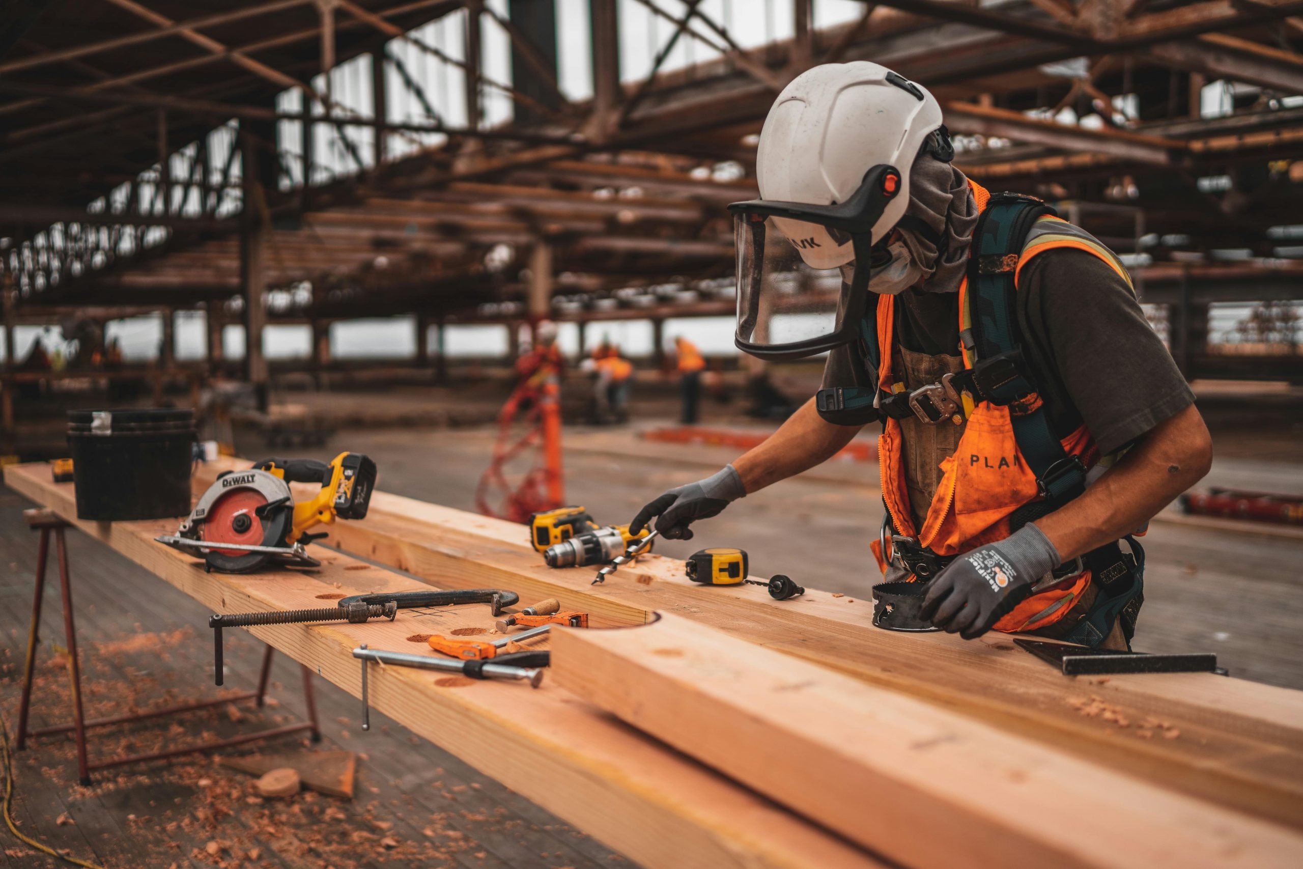construction worker working on a wood beam